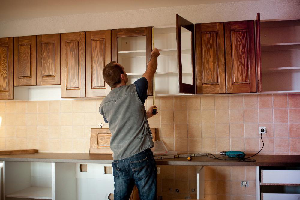 Contractor Measuring Kitchen Cabinets